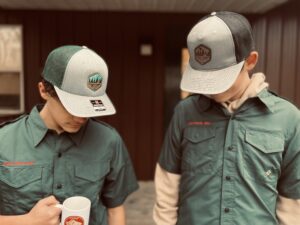 Photo of camp hats and uniforms available at the trading post